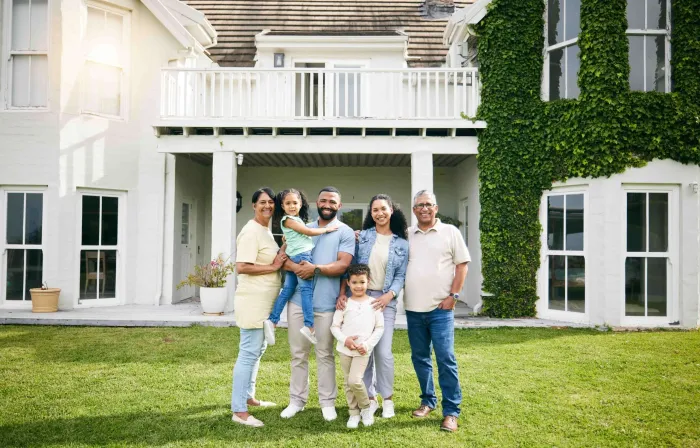 Multi-generational family standing in front of their home